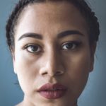 close-up photo of woman's face with red lipstick