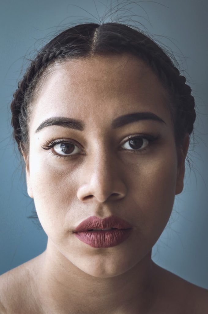 close-up photo of woman's face with red lipstick