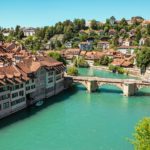 a bridge over a river with buildings on either side of it