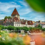 a building with a tower and a body of water in front of it