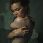 A woman with her arms around her chest