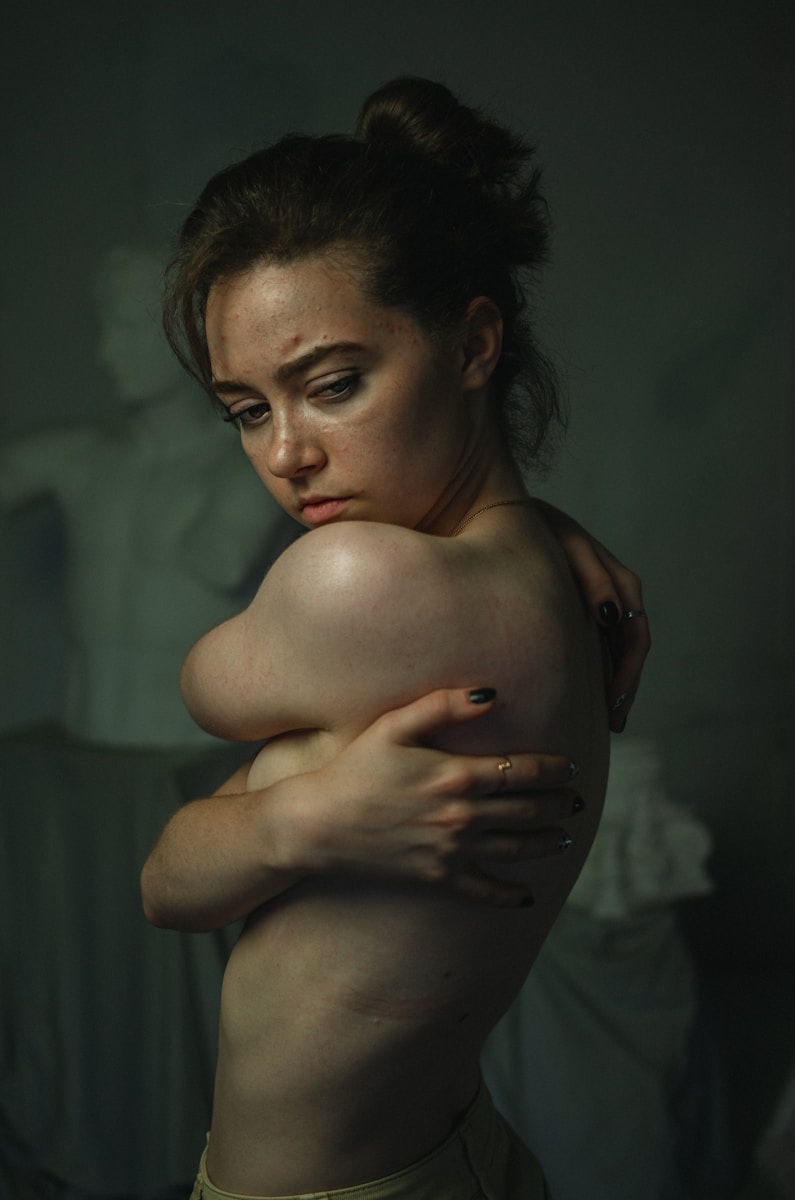 A woman with her arms around her chest