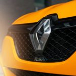 a close up of the front grill of a yellow sports car