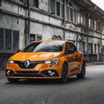 orange mercedes benz c class parked on street during daytime