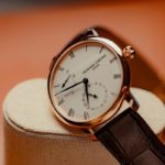 A close-up of a luxury rose gold wristwatch.