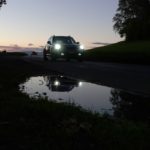 a car driving down a road at night