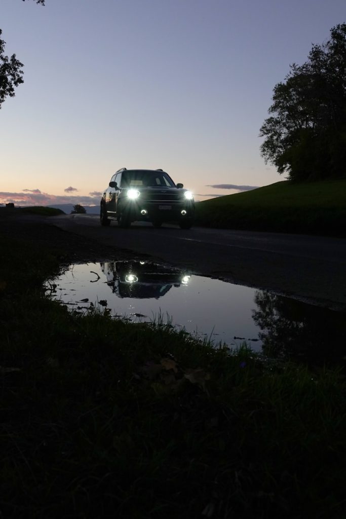 a car driving down a road at night