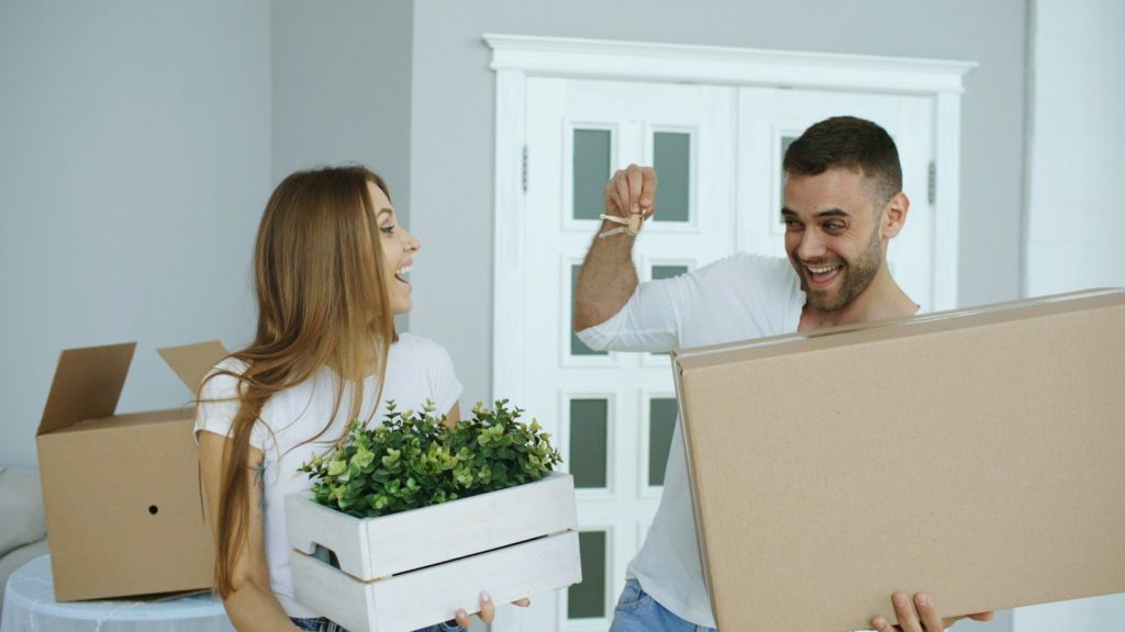 Couple happily moving into a new home